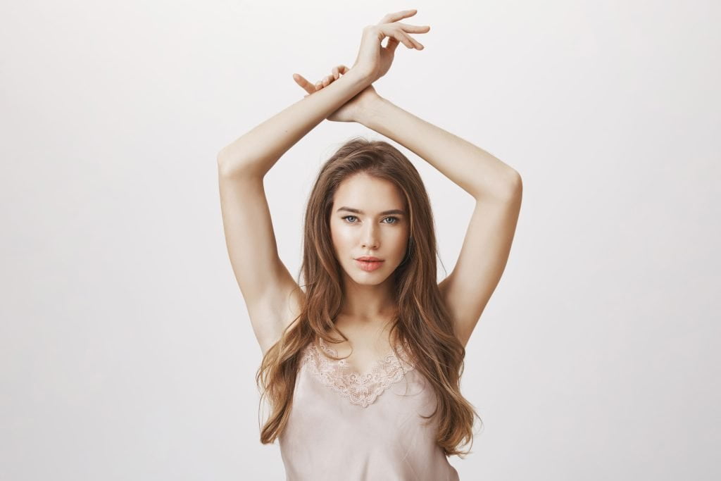 woman with hands up pose